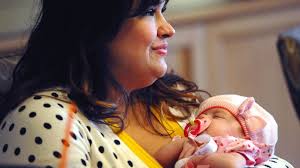 Ruby holding her baby