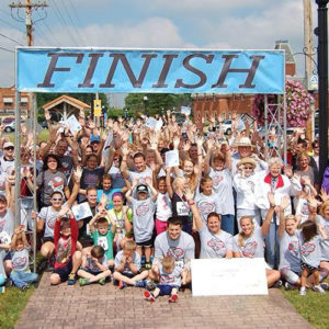 AFE 5K finish line with a large group of runners.